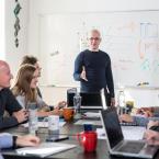 Group of coworkers sitting around a table in a training about bias