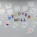 First Step Recovery wall covered in slogan submissions surrounding the words Recovery Wall