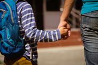 Mom holds her son's hand